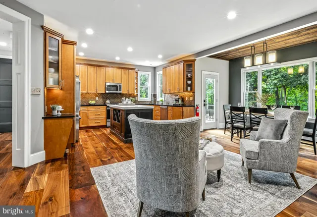 a living room with fireplace furniture and a large window