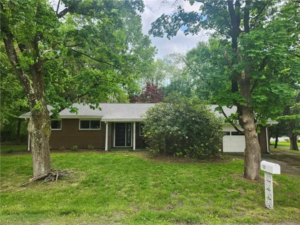 a view of house with a yard