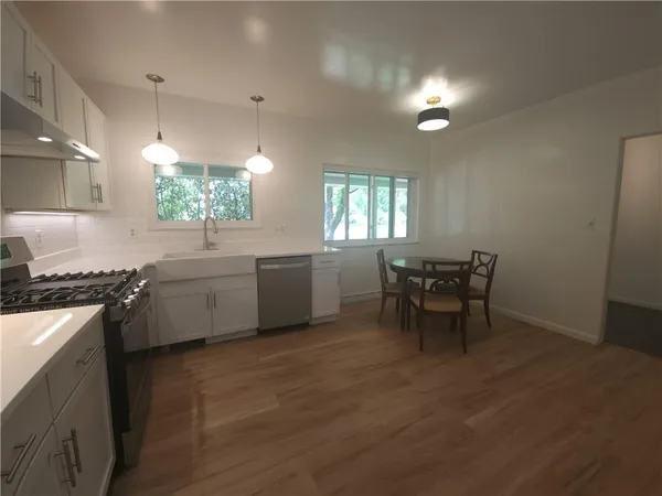 a kitchen with a table chairs and a stove