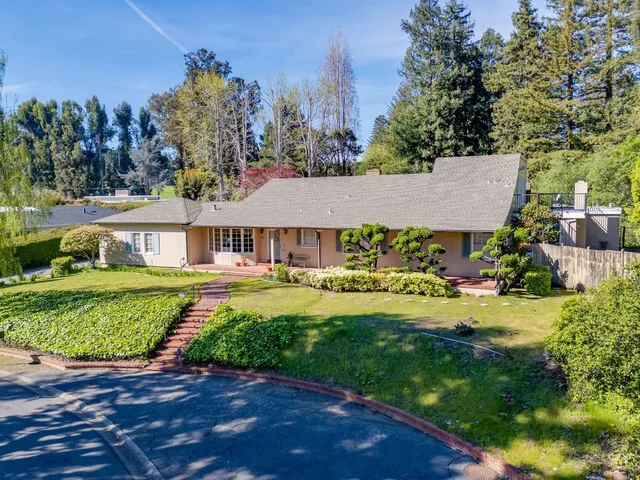 a front view of a house with a yard table and chairs
