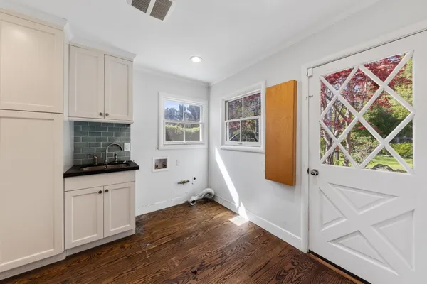 a view of an empty room with a fireplace and a window