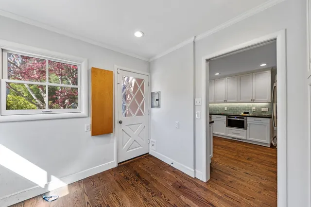 a bathroom with a granite countertop sink a mirror and shower curtain