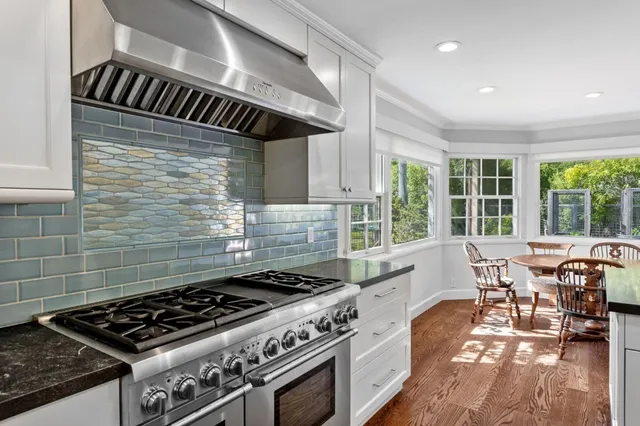a view of a patio with table and chairs and potted plants