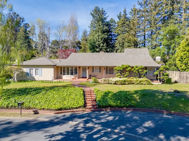 a view of a house with swimming pool and a yard