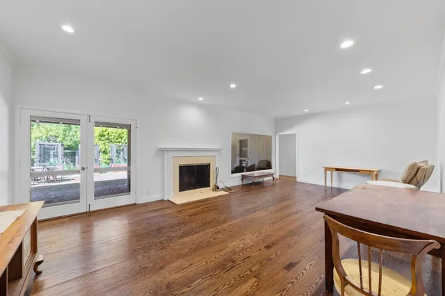a spacious bathroom with a double vanity sink a large mirror and a bathtub