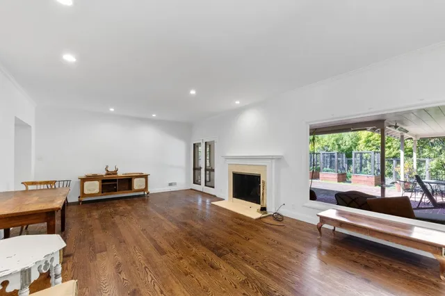 a bedroom with a bed and a dresser next to a window