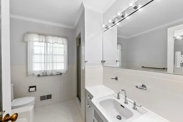 a white toilet sitting next to a shower curtain