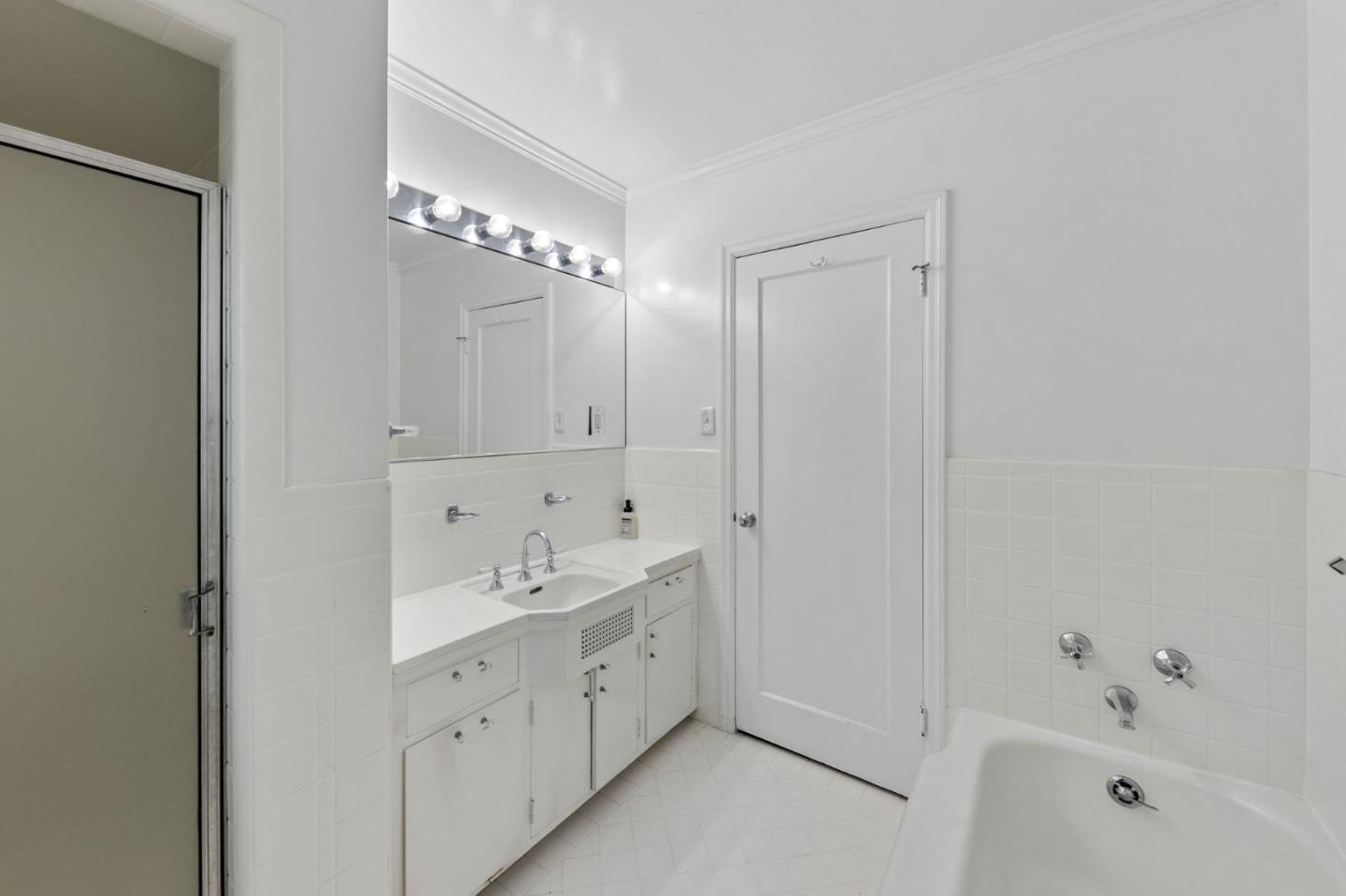 680 Fairway Circle Hillsborough, CA 94010 - Photo 37 of 83 a spacious bathroom with a double vanity sink a large mirror and a bathtub