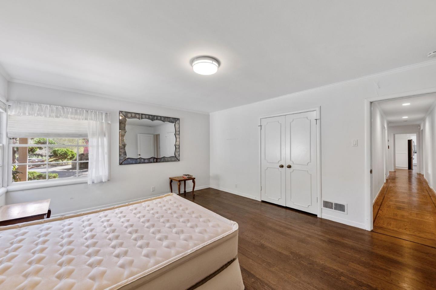 680 Fairway Circle Hillsborough, CA 94010 - Photo 38 of 83 a bedroom with a bed and a dresser next to a window