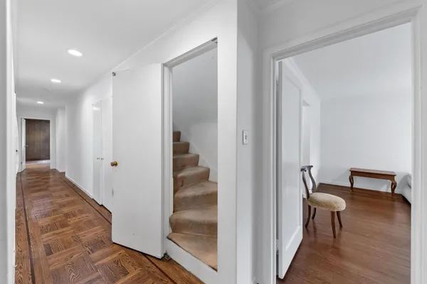 a view of empty room with wooden floor and cabinet