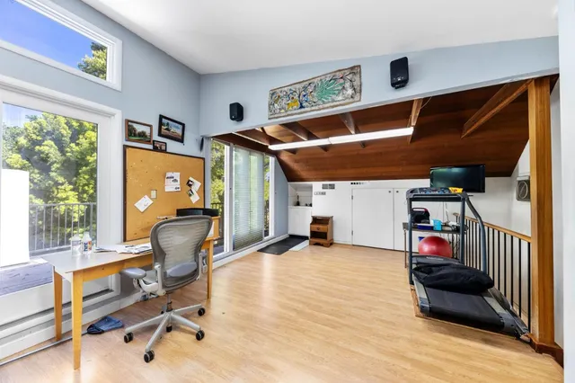 an empty room with windows fire place and windows