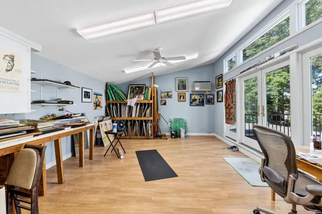 a room with pool table and a large window