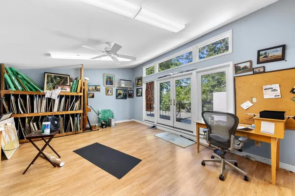 a living room with furniture and large windows