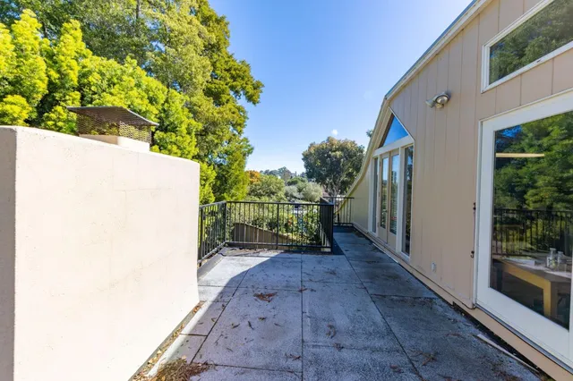 a view of a house with a backyard and tree