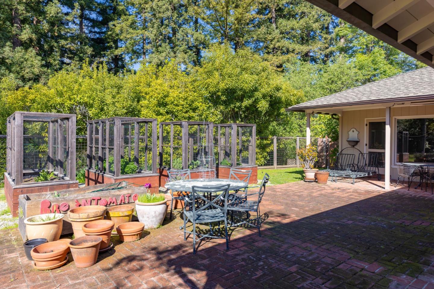 680 Fairway Circle Hillsborough, CA 94010 - Photo 71 of 83 a view of a patio with table and chairs potted plants and large tree