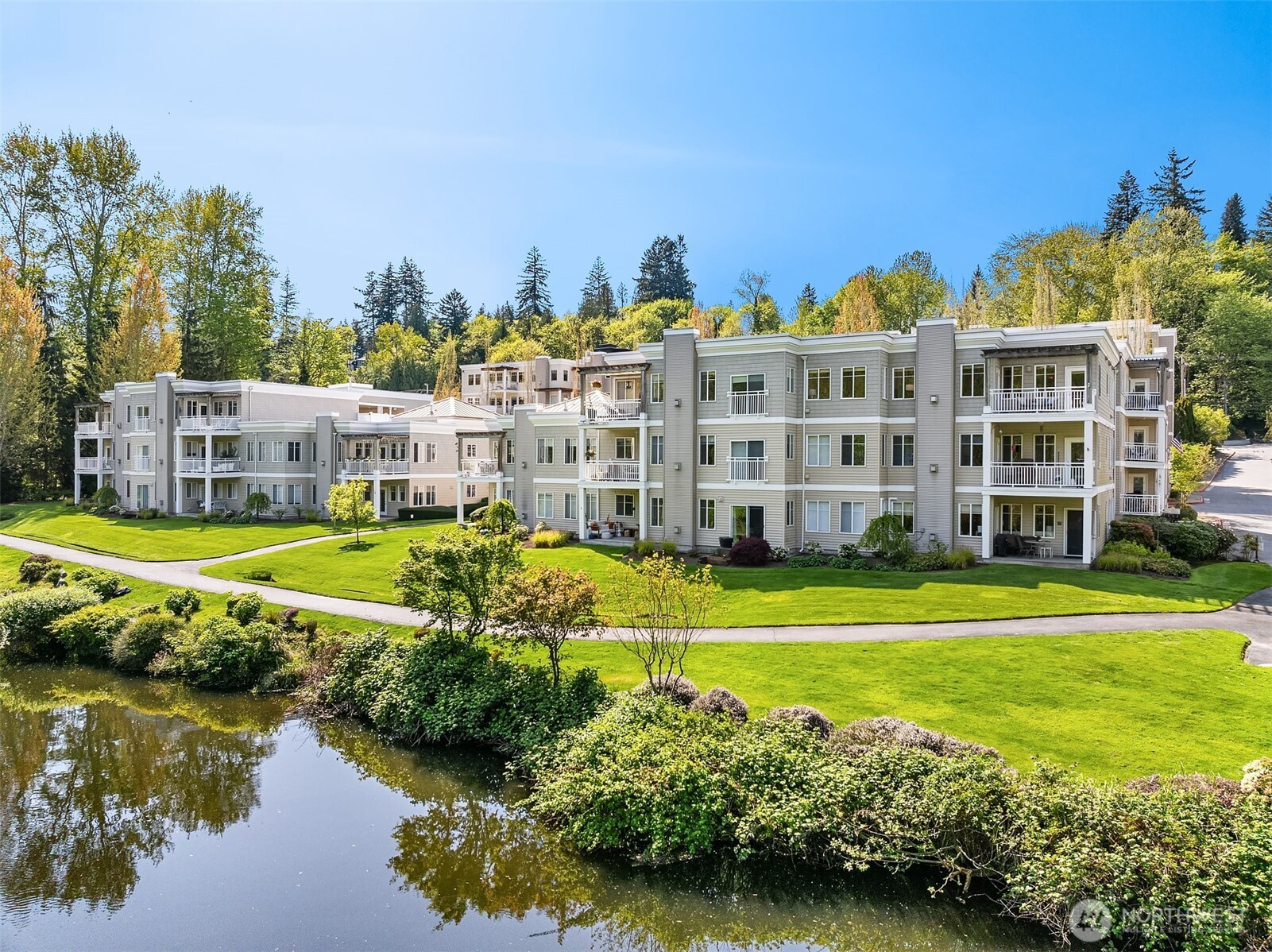 17432 Bothell Way Northeast, Unit B305 Bothell, WA 98011 - Photo 1 of 39 a view of a large building with a big yard and large trees