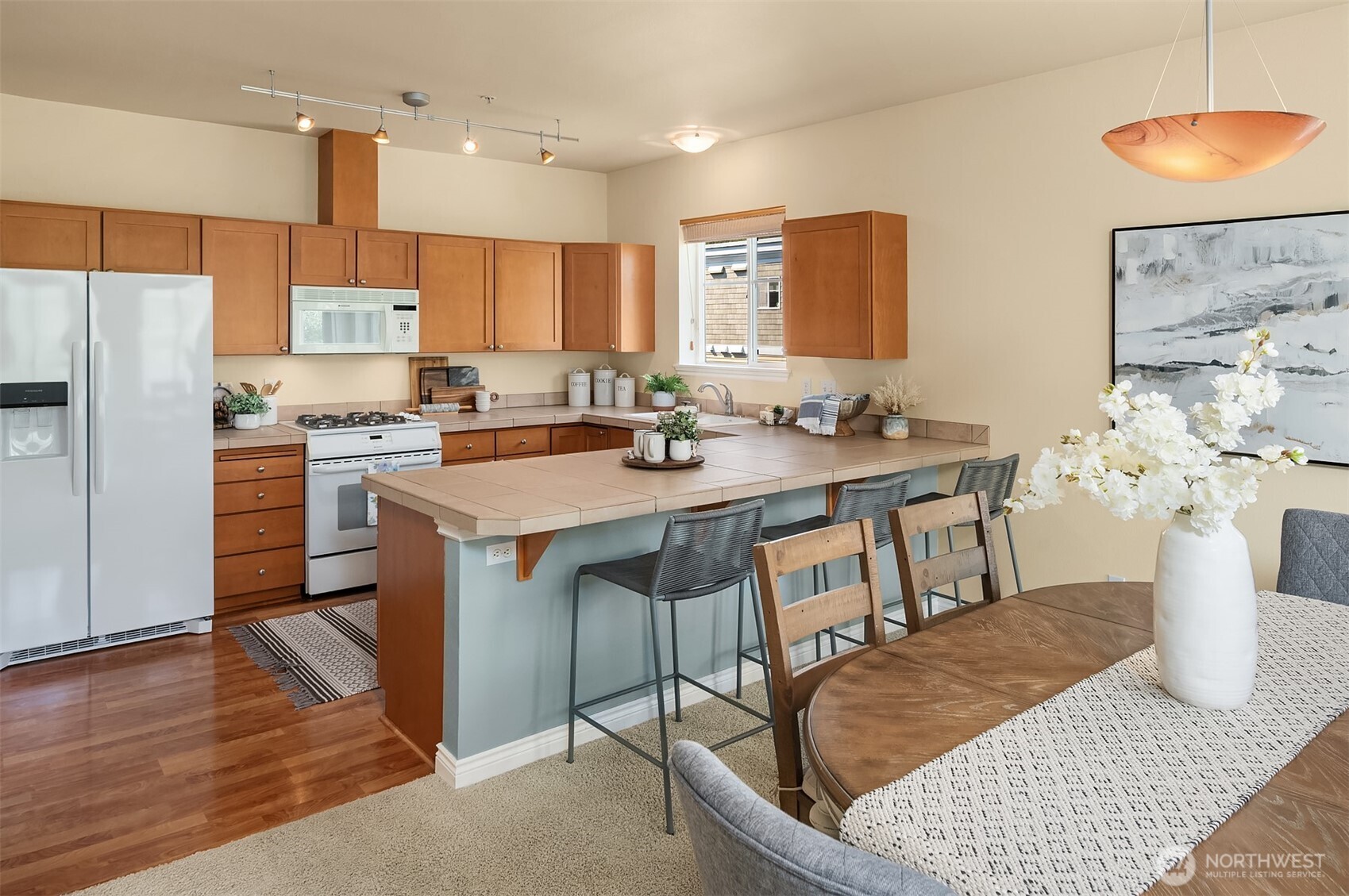 17432 Bothell Way Northeast, Unit B305 Bothell, WA 98011 - Photo 19 of 39 a kitchen with a table chairs sink and cabinets