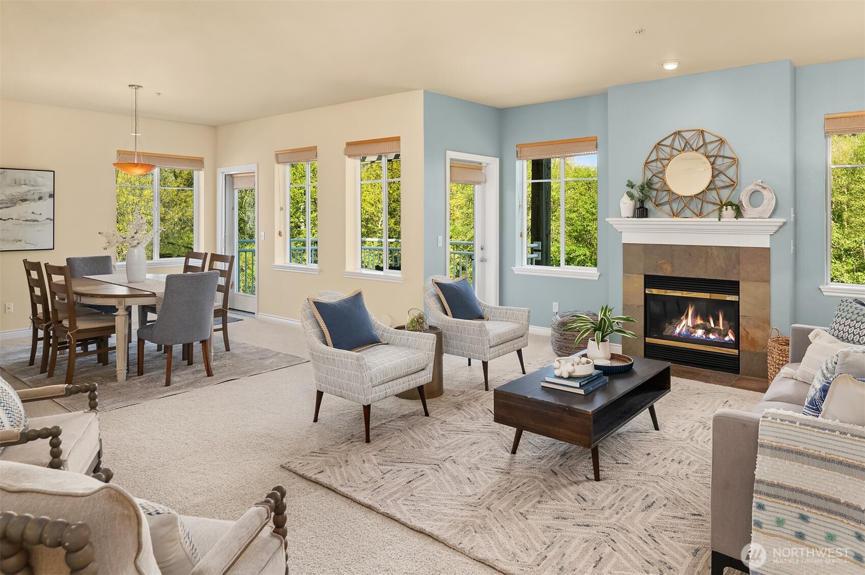17432 Bothell Way Northeast, Unit B305 Bothell, WA 98011 - Photo 10 of 39 a living room with furniture a fireplace a clock and a large window