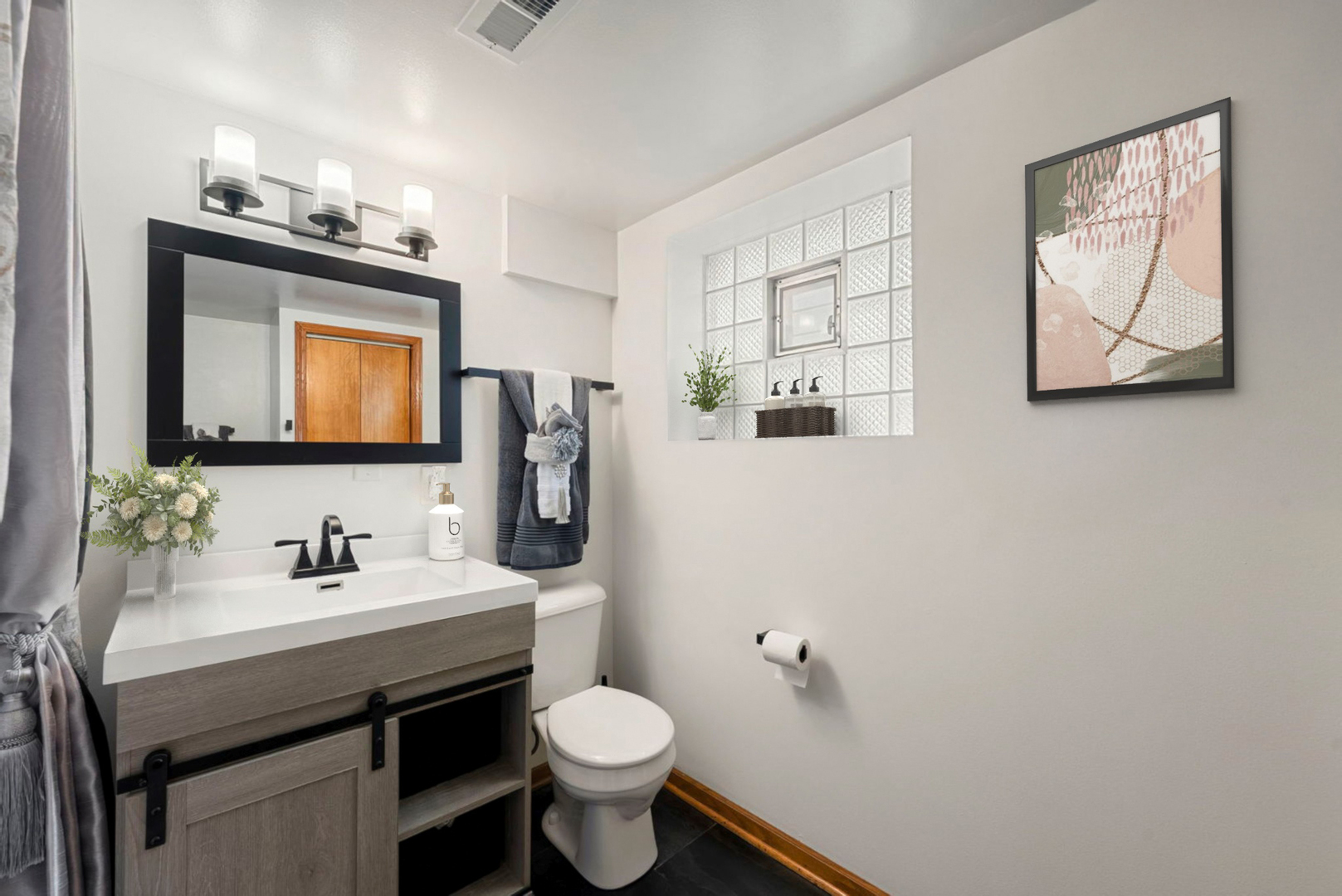 4613 Madison Avenue Brookfield, IL 60513 - Photo 19 of 33 a bathroom with a toilet a sink a mirror and a window