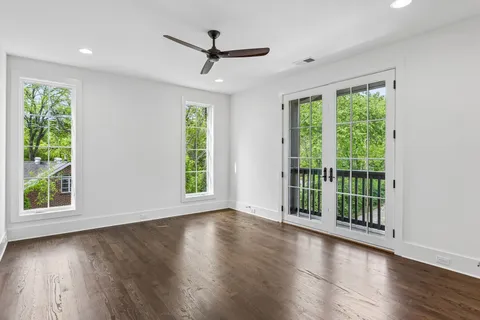 a view of wooden floor and windows in a room