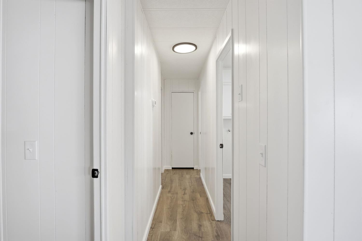 1200 South Carpenter Road, Unit 10 Modesto, CA 95351 - Photo 18 of 27 a view of a room with wooden floor and a bathroom
