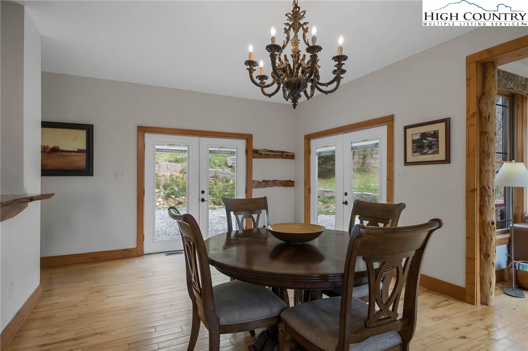 140 Spruce Hollow Road Beech Mountain, NC 28604 - Photo 16 of 50 a view of a dining room with furniture window and wooden floor