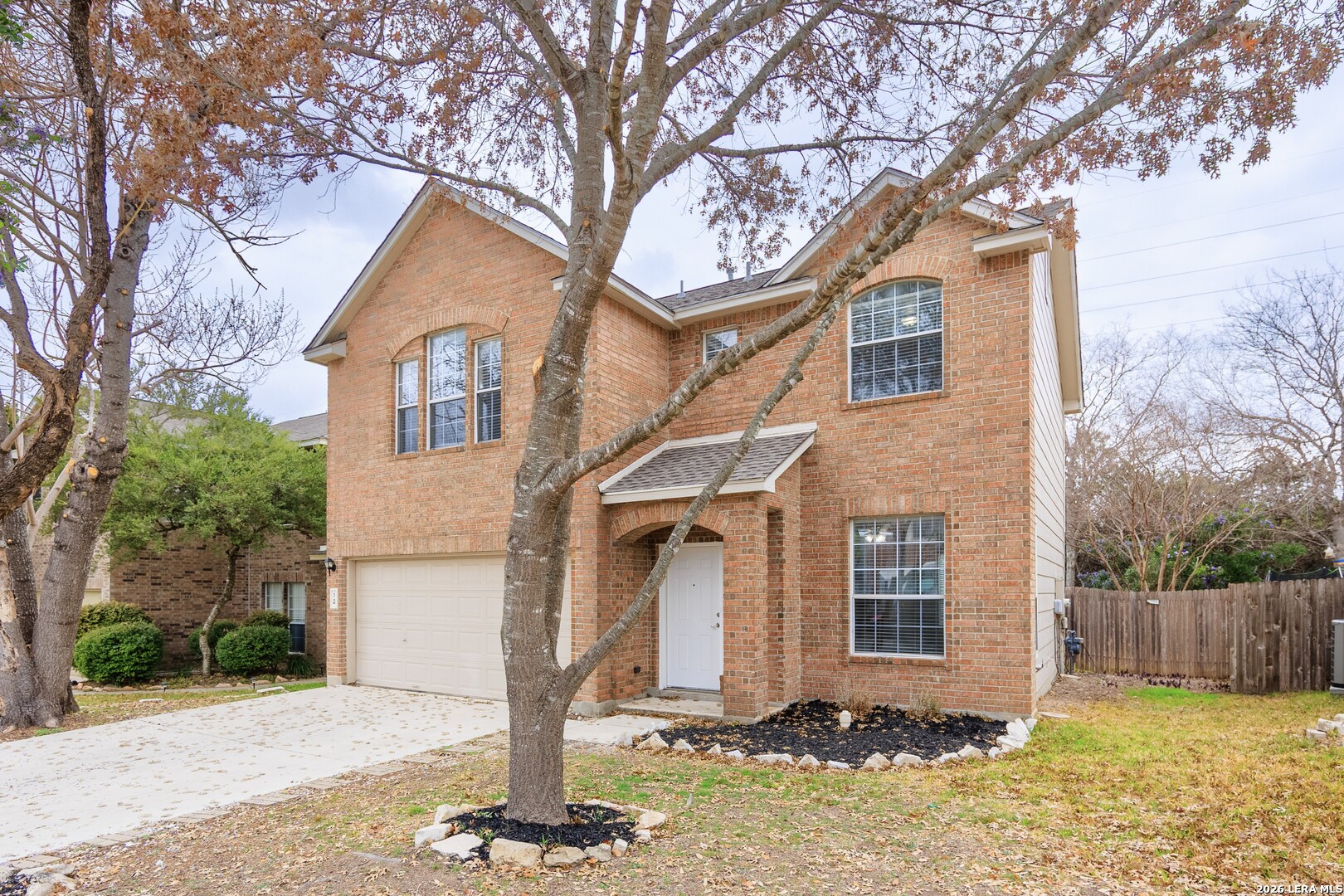 12 Lockspring San Antonio, TX 78254 - Photo 2 of 35 a front view of a house with a yard and garage
