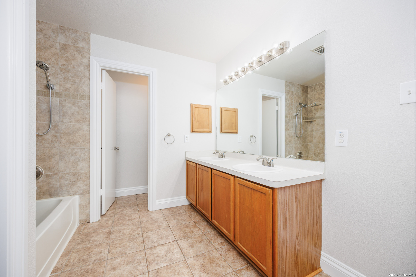 12 Lockspring San Antonio, TX 78254 - Photo 27 of 35 a bathroom with a sink a mirror and a bathtub