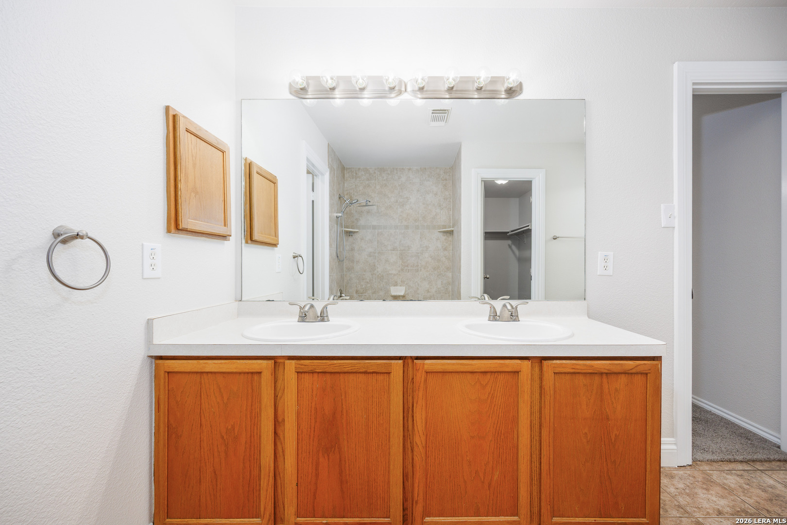 12 Lockspring San Antonio, TX 78254 - Photo 28 of 35 a bathroom with a granite countertop sink and a mirror