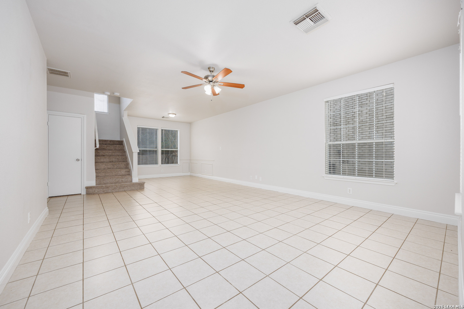 12 Lockspring San Antonio, TX 78254 - Photo 4 of 35 an empty room with windows and fan