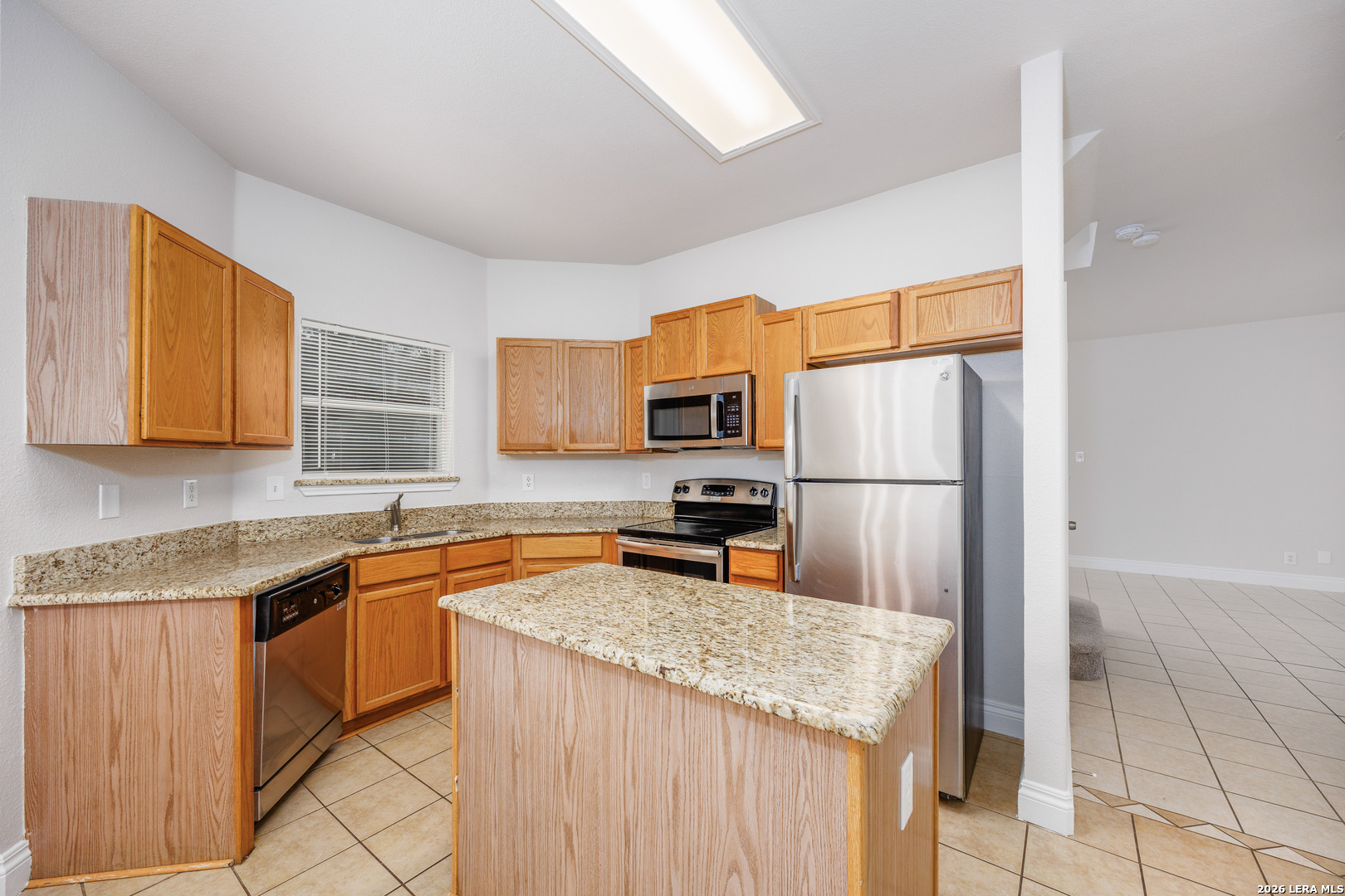 12 Lockspring San Antonio, TX 78254 - Photo 9 of 35 a kitchen with stainless steel appliances granite countertop a sink refrigerator and microwave