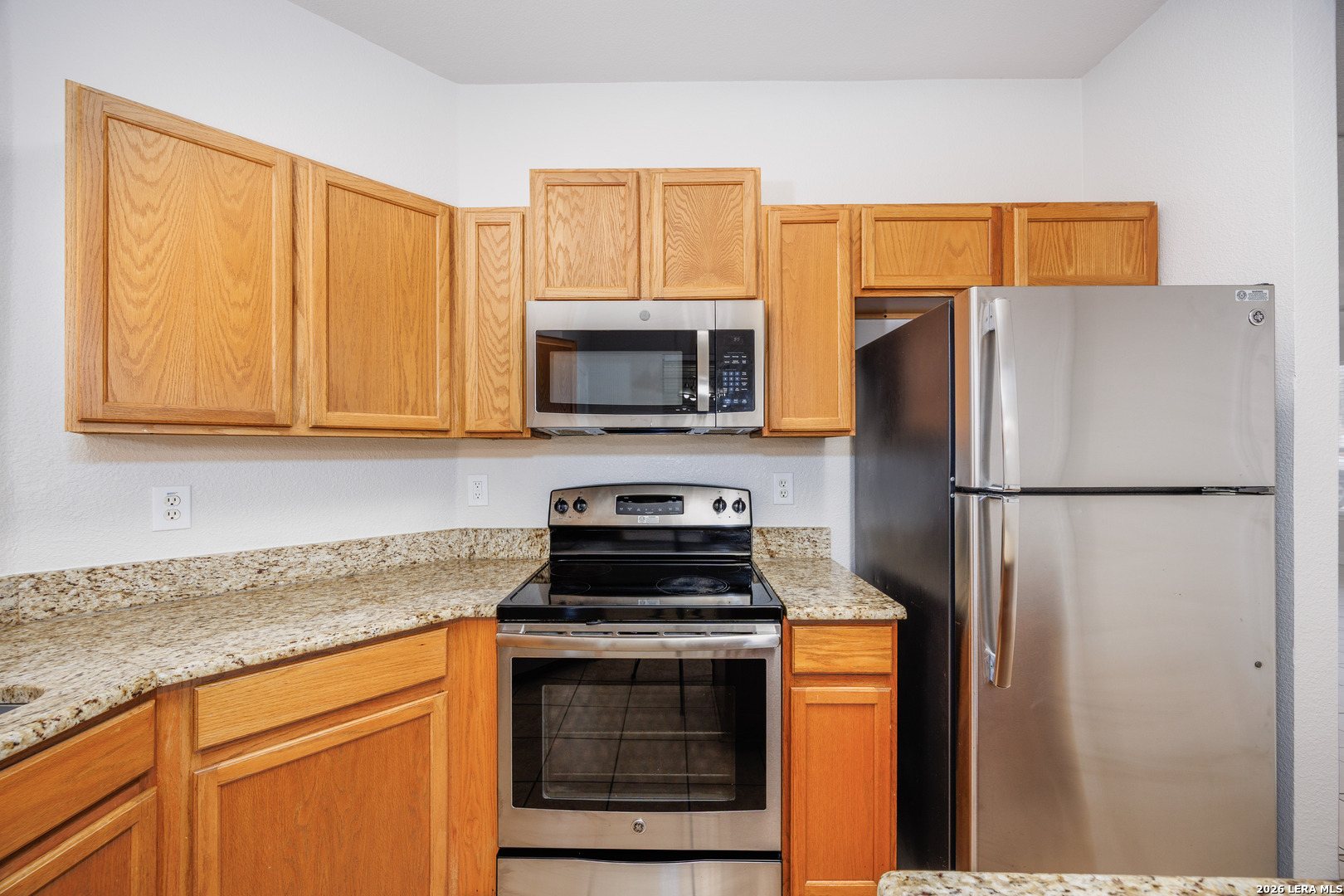 12 Lockspring San Antonio, TX 78254 - Photo 10 of 35 a kitchen with a refrigerator stove and microwave