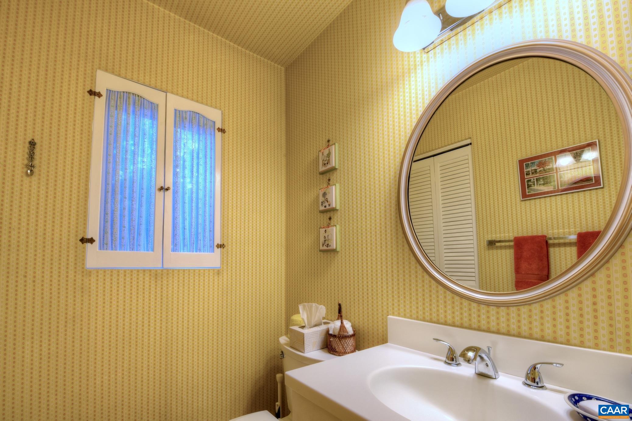 727 Village Road Charlottesville, VA 22903 - Photo 27 of 34 a bathroom with a sink and a mirror