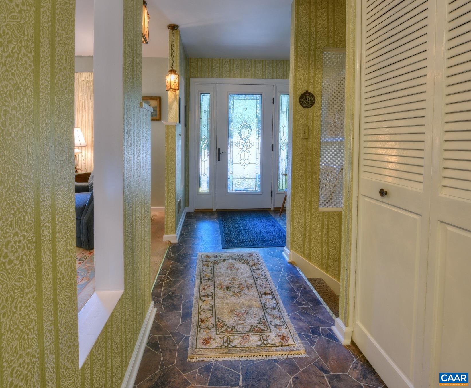 727 Village Road Charlottesville, VA 22903 - Photo 5 of 34 a view of a hallway with wooden floor and a bathroom