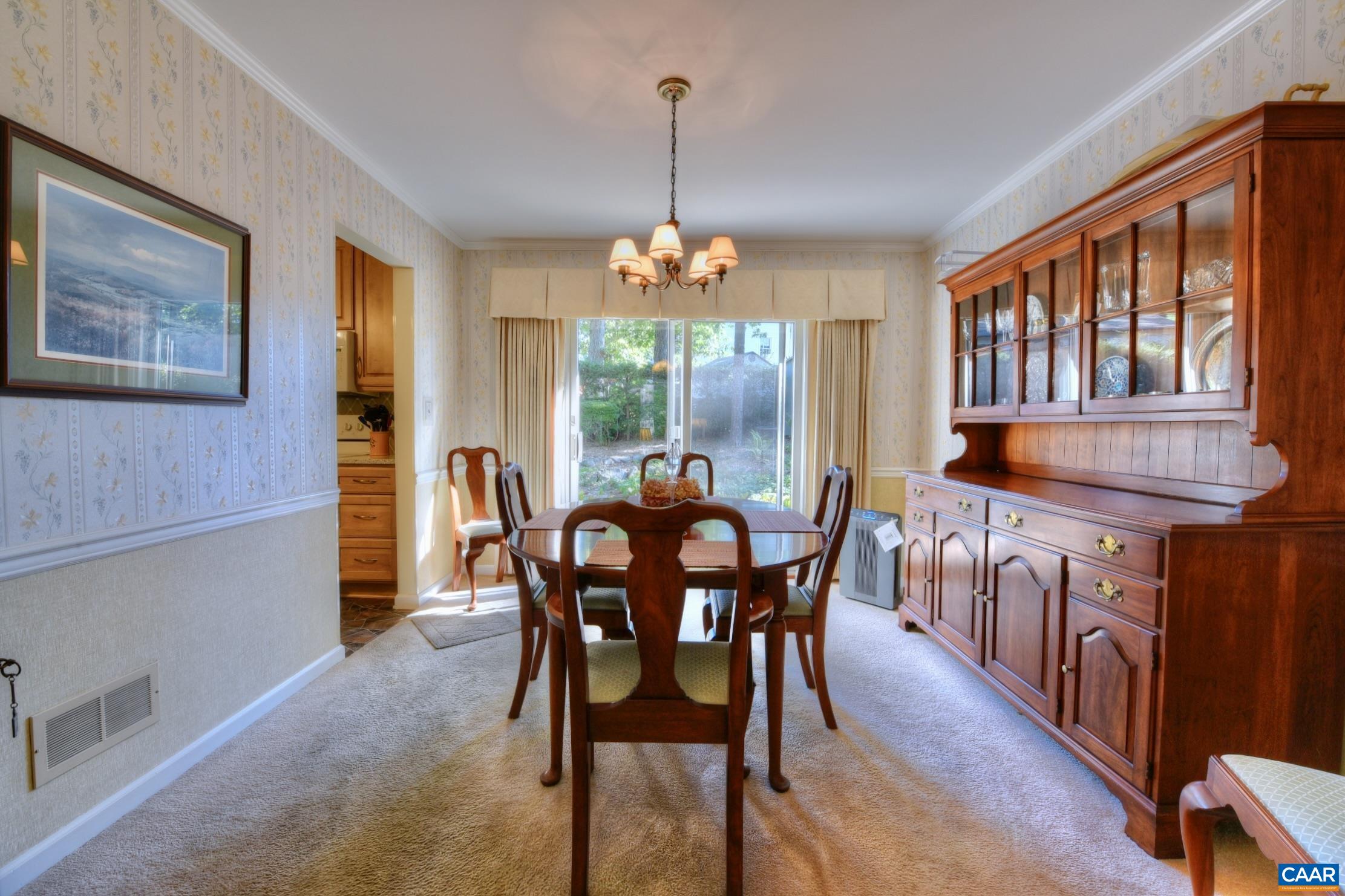 727 Village Road Charlottesville, VA 22903 - Photo 8 of 34 a dining room with furniture a chandelier and window