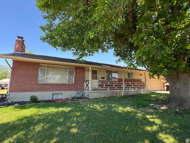 1611 South 75 East Bountiful, UT 84010 - Photo 2 of 6 Brick exterior featuring a covered porch with decorative railing
