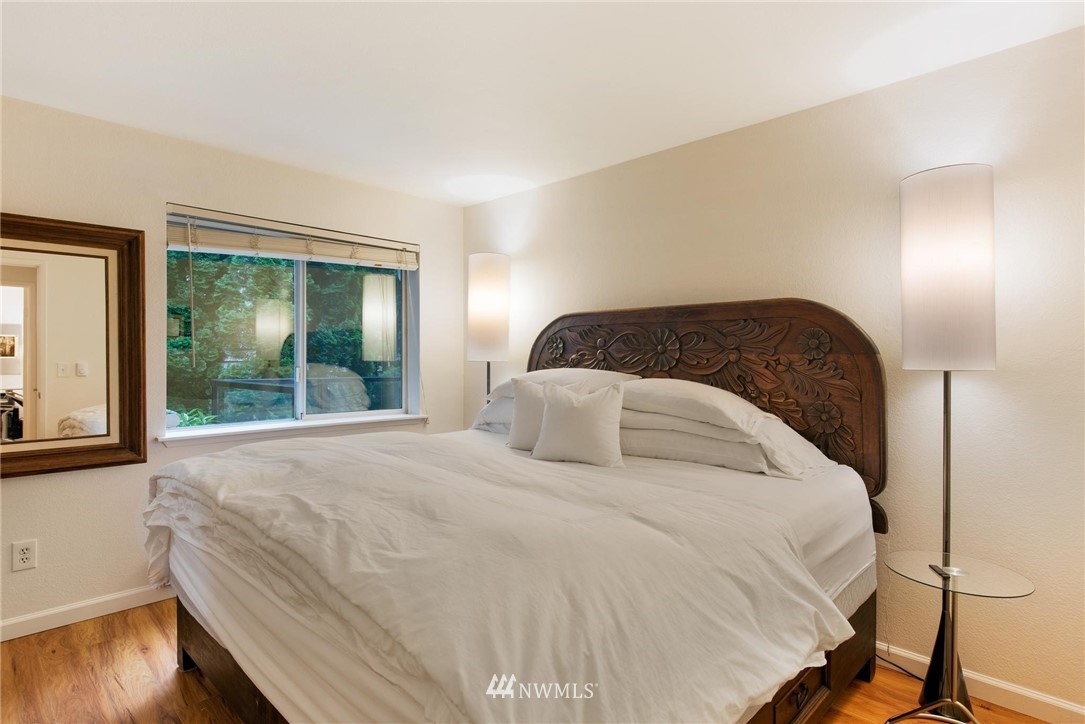 2244 13th Avenue West, Unit 115 Seattle, WA 98119 - Photo 12 of 19 a bedroom with a bed and wooden floor