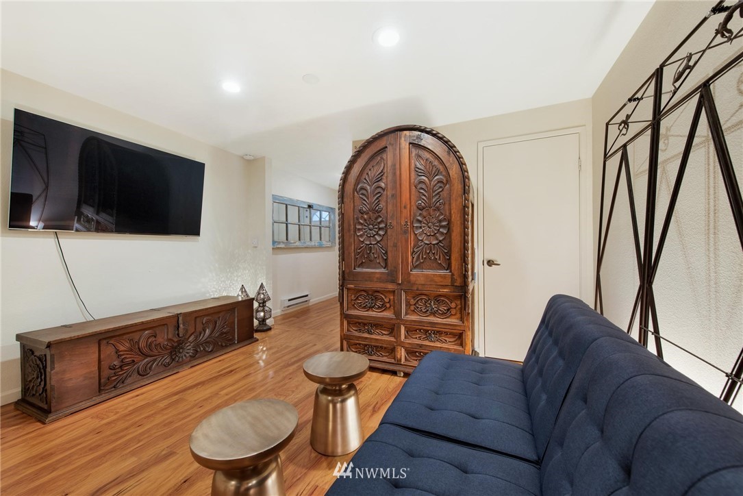 2244 13th Avenue West, Unit 115 Seattle, WA 98119 - Photo 15 of 19 a living room with furniture and a flat screen tv