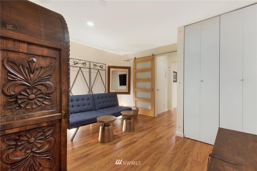 2244 13th Avenue West, Unit 115 Seattle, WA 98119 - Photo 16 of 19 a living room with furniture and a wooden floor