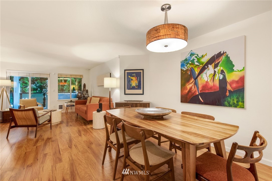 2244 13th Avenue West, Unit 115 Seattle, WA 98119 - Photo 4 of 19 a view of a dining room with furniture and wooden floor