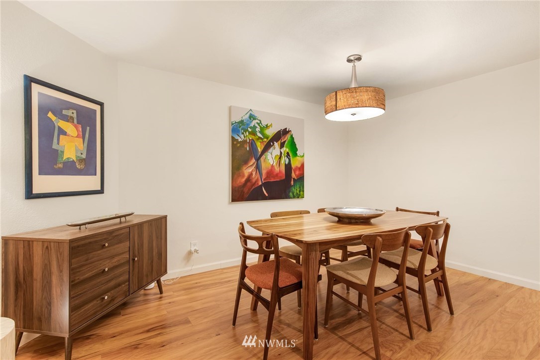 2244 13th Avenue West, Unit 115 Seattle, WA 98119 - Photo 5 of 19 a view of a dining room with furniture and wooden floor