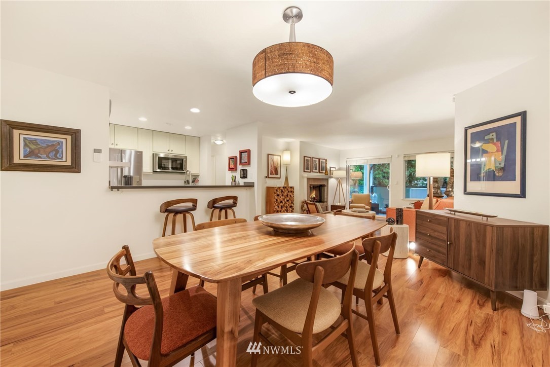 2244 13th Avenue West, Unit 115 Seattle, WA 98119 - Photo 7 of 19 a view of a dining room with furniture and wooden floor