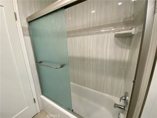 a bathroom with a shower and a sink