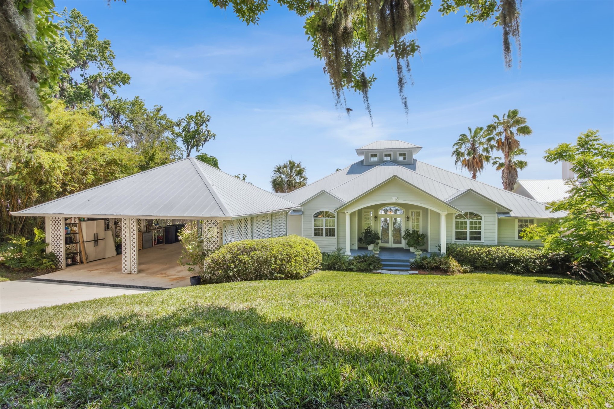 4333 Seminole Street Starke, FL 32091 - Photo 1 of 33 a front view of a house with a yard and potted plants