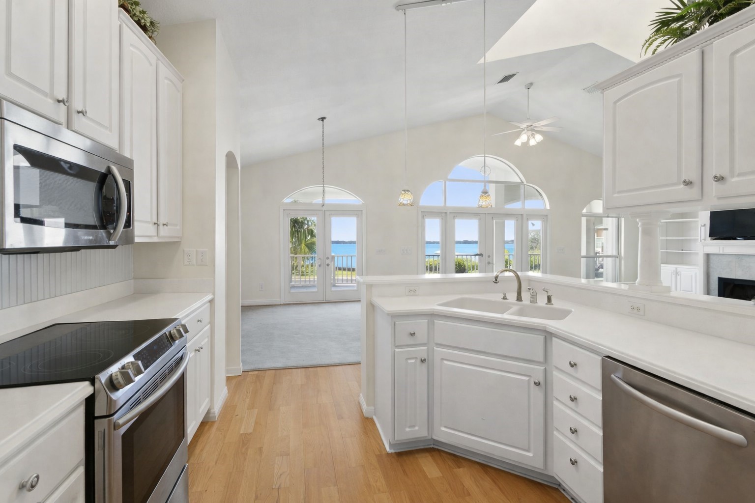 4333 Seminole Street Starke, FL 32091 - Photo 8 of 33 a kitchen with granite countertop a sink stainless steel appliances and white cabinets