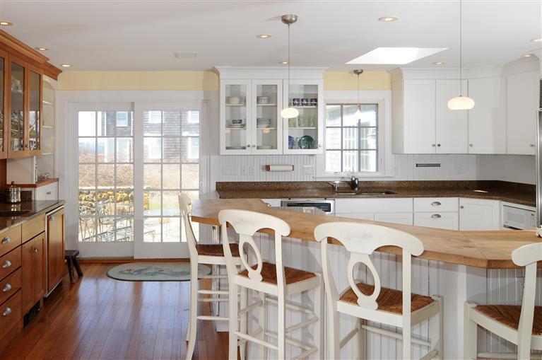28 Point Road Marion, MA 02738 - Photo 7 of 11 a large white kitchen with a lot of cabinets and wooden floor