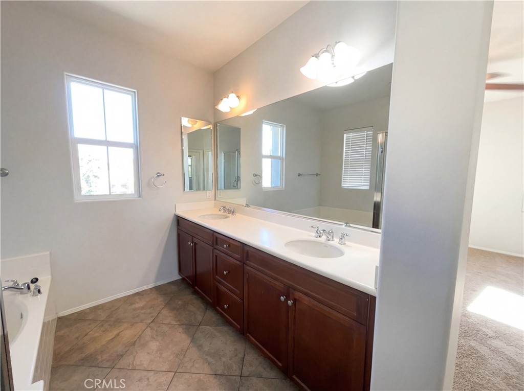28745 Edenton Way Temecula, CA 92591 - Photo 11 of 23 a spacious bathroom with a double vanity sink a mirror and a