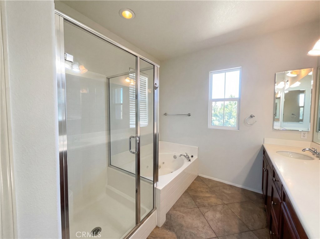 28745 Edenton Way Temecula, CA 92591 - Photo 12 of 23 a bathroom with a tub sink and mirror