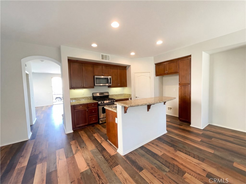 28745 Edenton Way Temecula, CA 92591 - Photo 2 of 23 a large kitchen with stainless steel appliances kitchen island granite countertop a large counter top and a stove top oven