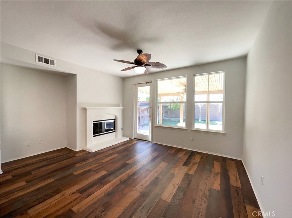 28745 Edenton Way Temecula, CA 92591 - Photo 6 of 23 a view of an empty room with wooden floor and a window